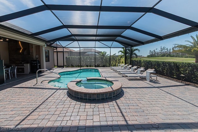 view of swimming pool with glass enclosure, a pool with connected hot tub, and a patio area