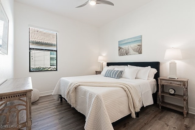 bedroom with ceiling fan, baseboards, and wood finished floors