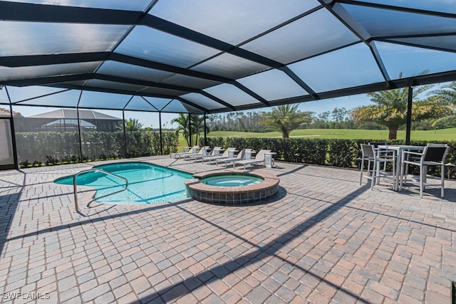 view of pool featuring a lanai, a patio area, and a pool with connected hot tub