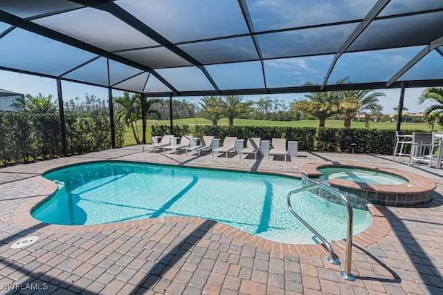 view of pool with a pool with connected hot tub, a patio area, and a lanai