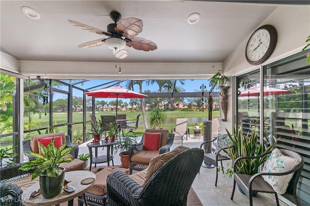 sunroom featuring a ceiling fan