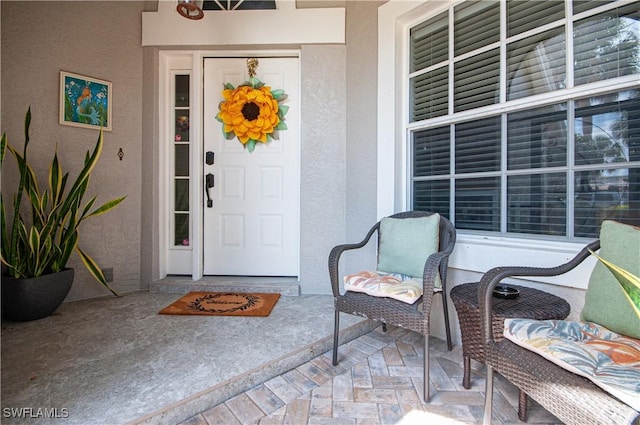 entrance to property with stucco siding