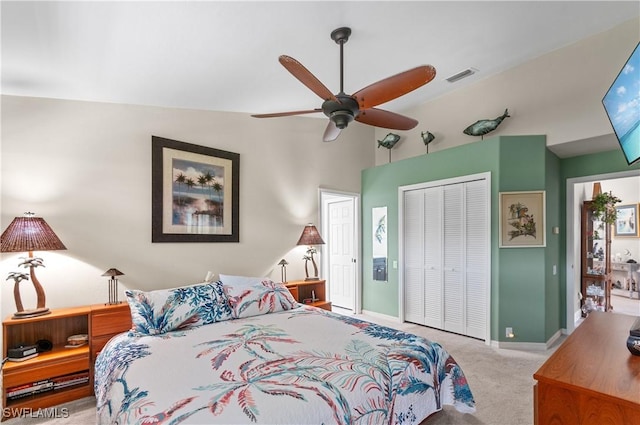 carpeted bedroom featuring baseboards, visible vents, vaulted ceiling, and a closet