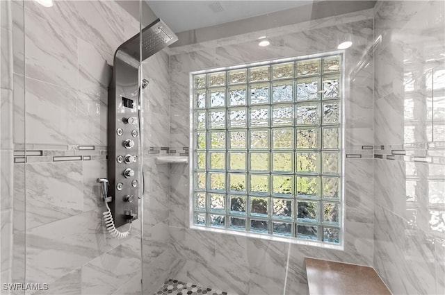 bathroom featuring plenty of natural light and walk in shower