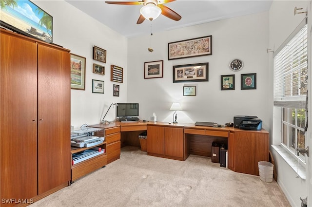 home office featuring light colored carpet and ceiling fan