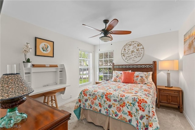 carpeted bedroom featuring ceiling fan and baseboards