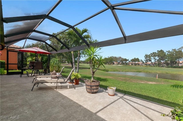 view of patio / terrace with a lanai and a water view