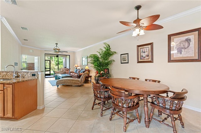 dining area featuring ornamental molding, light tile patterned flooring, visible vents, and a ceiling fan