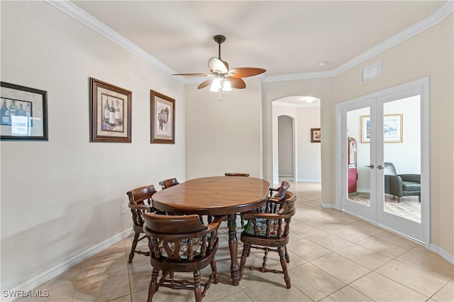 dining room with baseboards, ornamental molding, and french doors