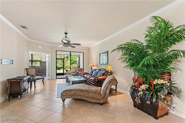 living room featuring ornamental molding, visible vents, and light tile patterned floors