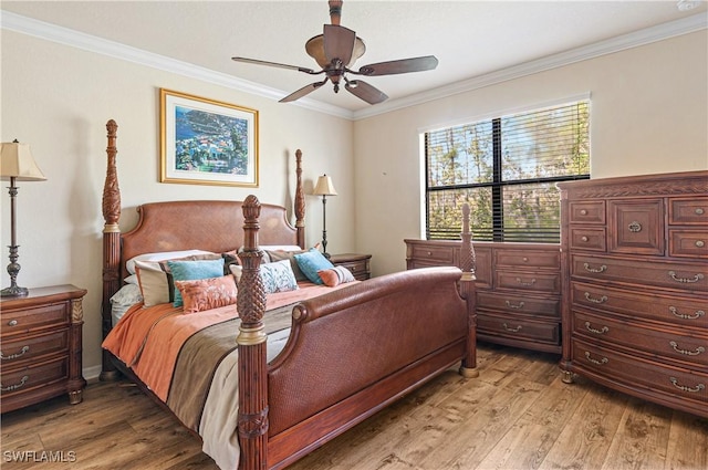 bedroom featuring light wood-style flooring, ornamental molding, and a ceiling fan