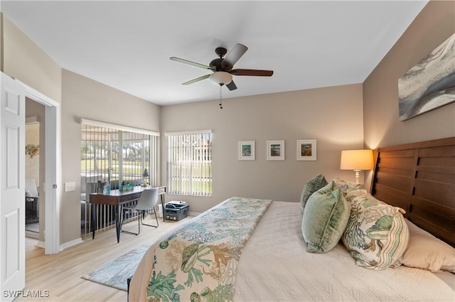 bedroom featuring wood finished floors, a ceiling fan, and baseboards