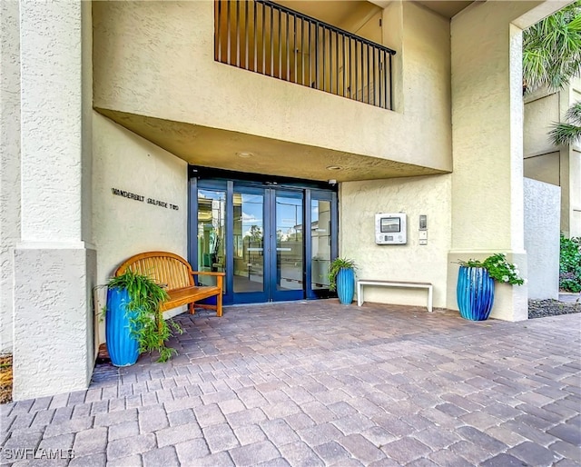 doorway to property with french doors and stucco siding