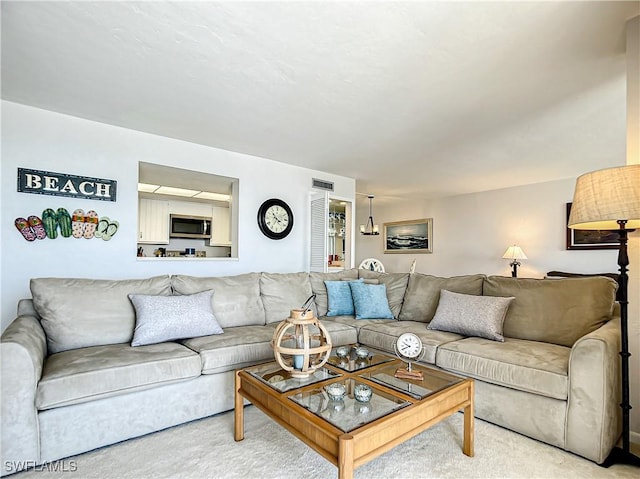 carpeted living room with visible vents