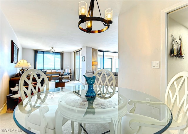 dining space with expansive windows and a notable chandelier