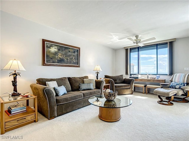 living area with carpet floors and a ceiling fan