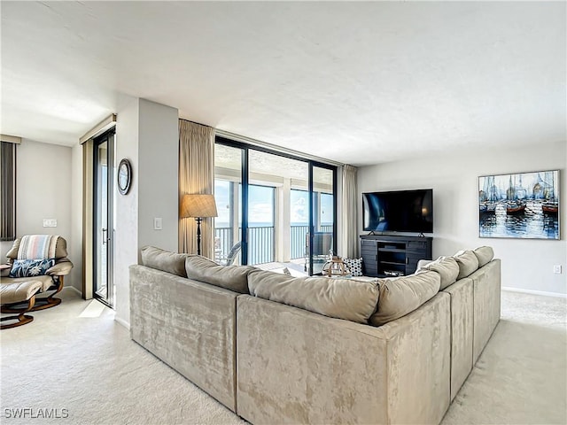 living room with a wall of windows, light colored carpet, and baseboards