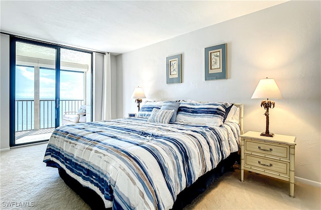 bedroom featuring access to exterior, expansive windows, baseboards, and carpet flooring