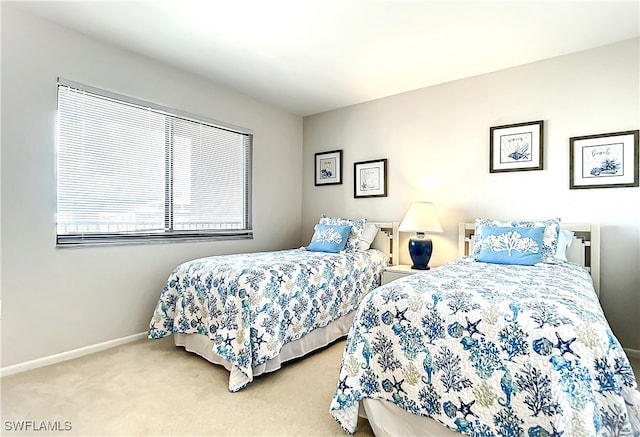 bedroom with carpet floors and baseboards