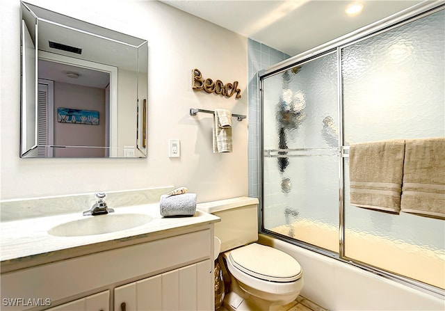 full bathroom with shower / bath combination with glass door, vanity, and toilet