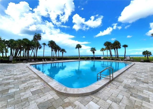 community pool featuring a patio area and fence