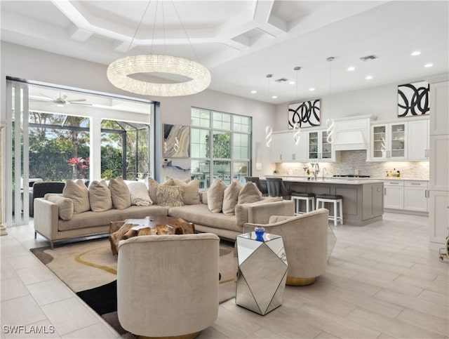 living room with coffered ceiling, recessed lighting, visible vents, and a high ceiling