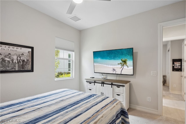 bedroom with light carpet, ceiling fan, visible vents, and baseboards