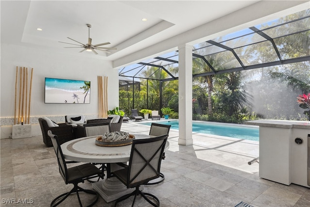 view of patio / terrace featuring an outdoor pool, ceiling fan, a lanai, and an outdoor hangout area