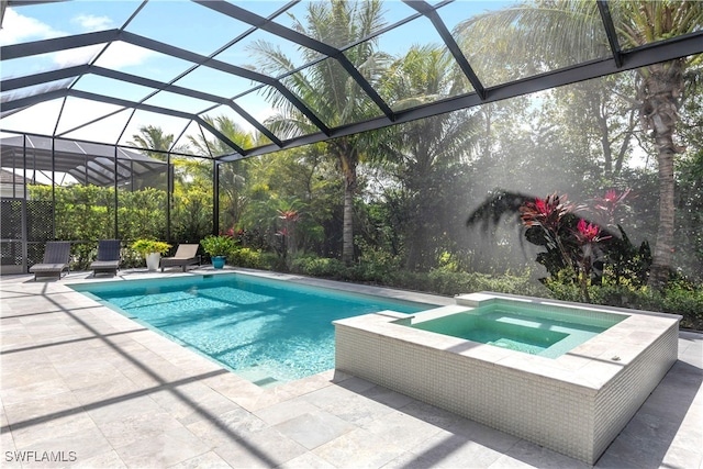 view of swimming pool featuring glass enclosure, a pool with connected hot tub, and a patio