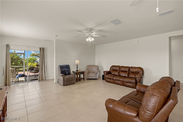 living area with light tile patterned floors, ceiling fan, and visible vents