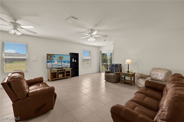 living area with a ceiling fan, visible vents, and light tile patterned floors