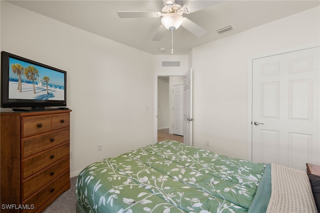 carpeted bedroom featuring ceiling fan, visible vents, and baseboards