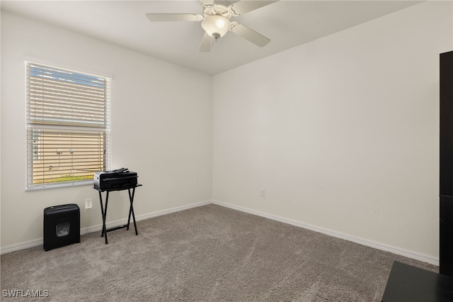 empty room with carpet, baseboards, and a ceiling fan