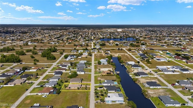 birds eye view of property with a residential view and a water view