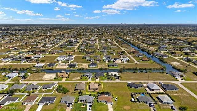 drone / aerial view with a water view and a residential view