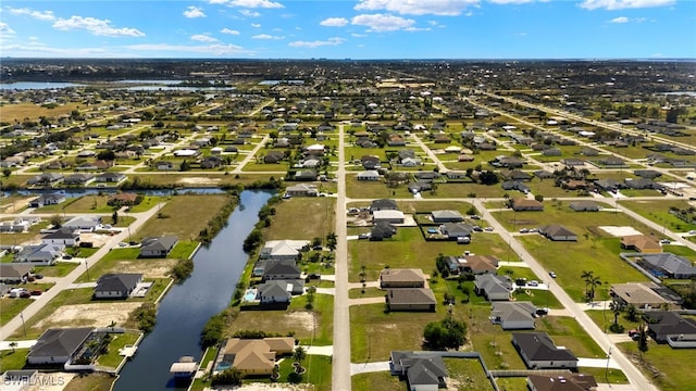 bird's eye view featuring a water view and a residential view