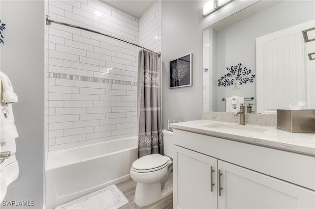 full bath with shower / bath combo, vanity, toilet, and wood finished floors