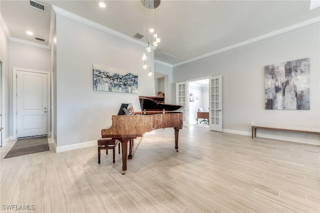 sitting room featuring french doors, light wood-style flooring, visible vents, and baseboards