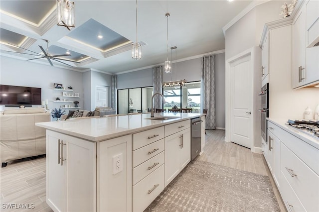 kitchen with coffered ceiling, a sink, white cabinetry, ornamental molding, and appliances with stainless steel finishes