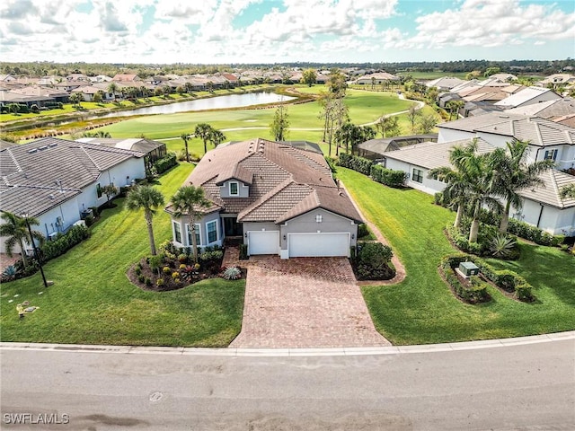 aerial view with golf course view, a water view, and a residential view