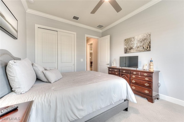 bedroom featuring crown molding, visible vents, a closet, and light colored carpet