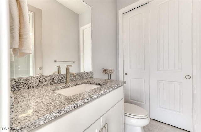 bathroom featuring vanity and toilet