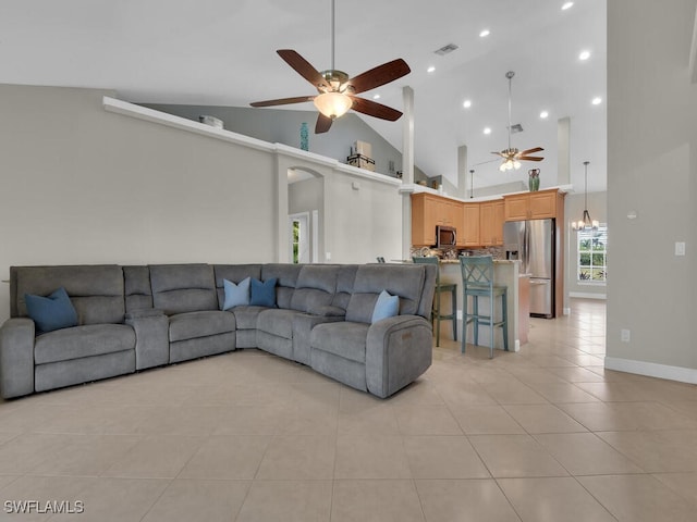 living area featuring light tile patterned floors, high vaulted ceiling, recessed lighting, visible vents, and a ceiling fan