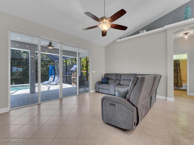 living area with lofted ceiling, light tile patterned flooring, a sunroom, and baseboards