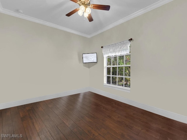 spare room featuring crown molding, baseboards, ceiling fan, and dark wood-style flooring