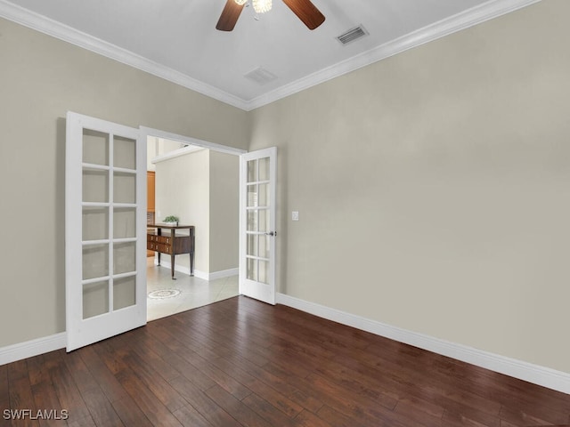 unfurnished room with visible vents, baseboards, french doors, hardwood / wood-style floors, and crown molding