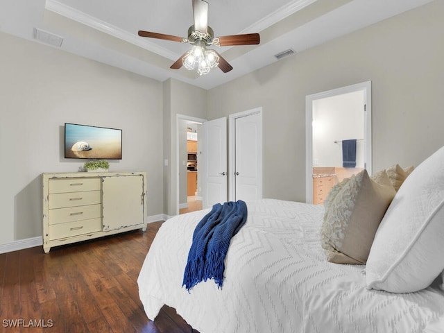 bedroom featuring wood finished floors, visible vents, and baseboards