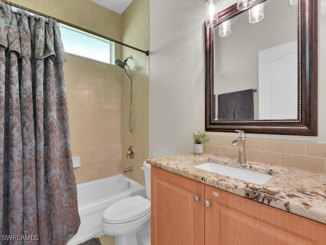 bathroom with toilet, shower / bathtub combination with curtain, and vanity