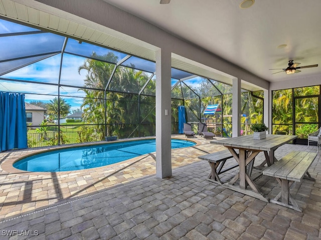 pool with ceiling fan, outdoor dining space, a patio area, and a lanai