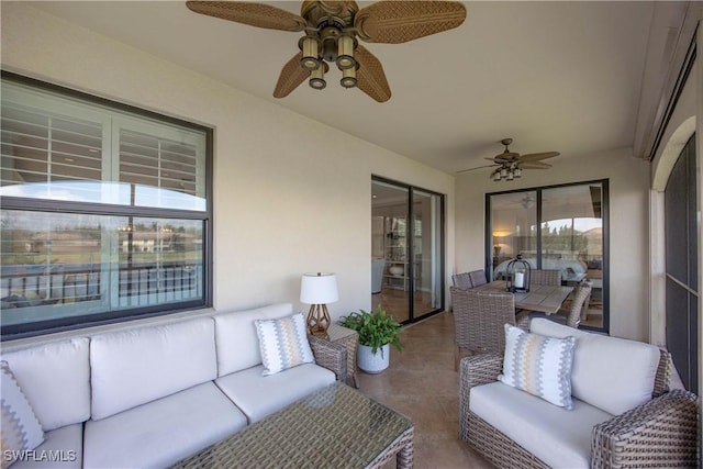 sunroom / solarium featuring a ceiling fan and a wealth of natural light